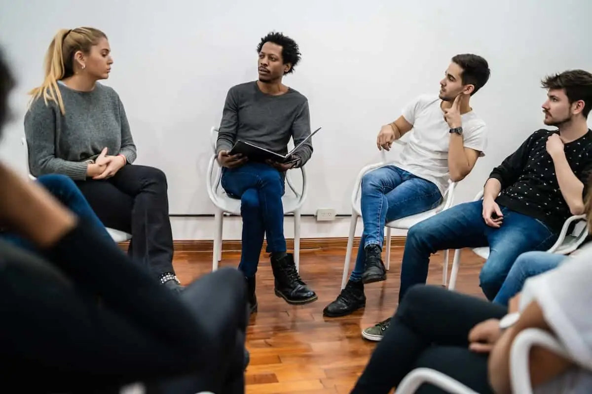 Adults in a circle during addiction group therapy session